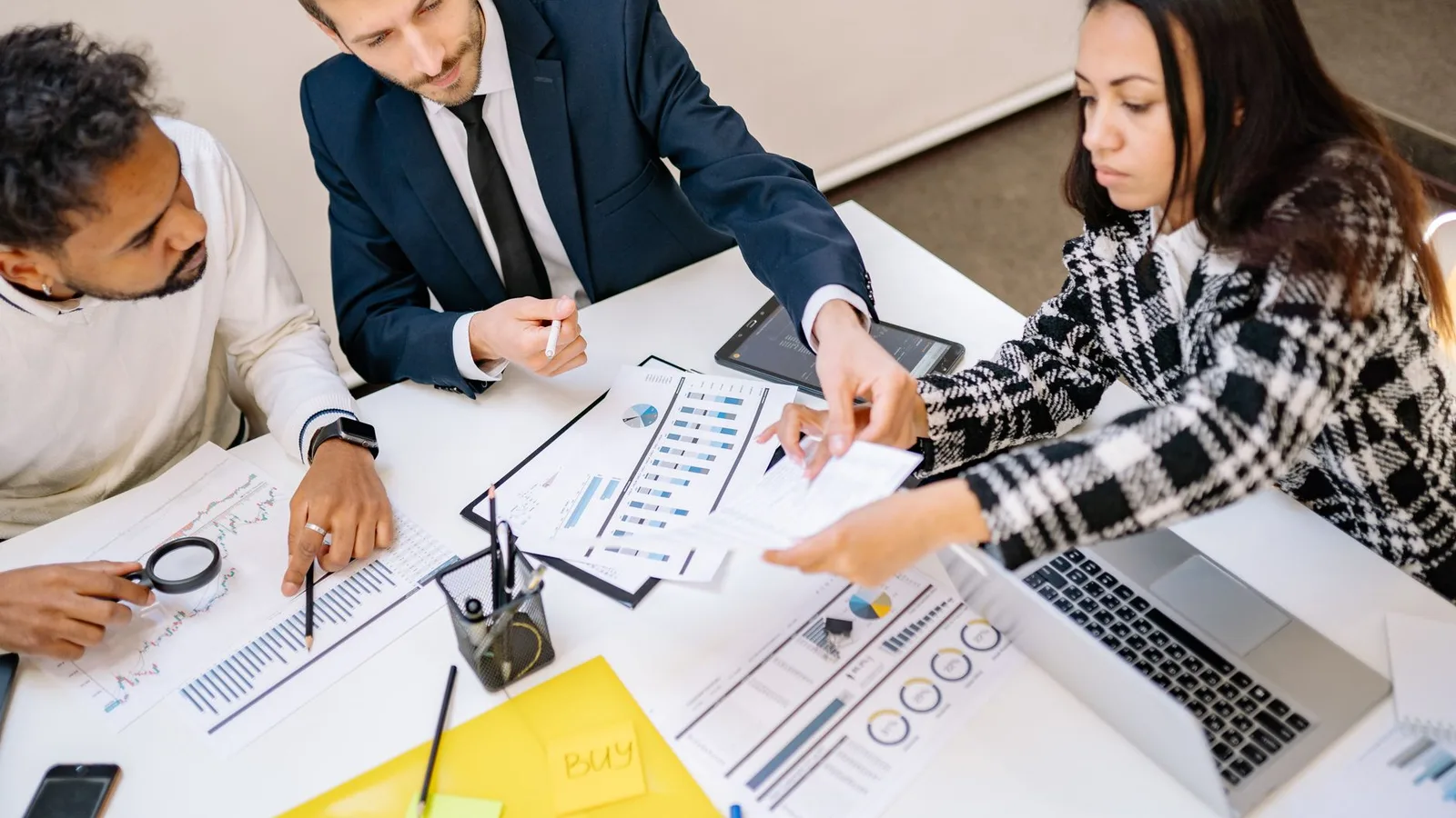 Colleagues reviewing charts and documents together at a desk