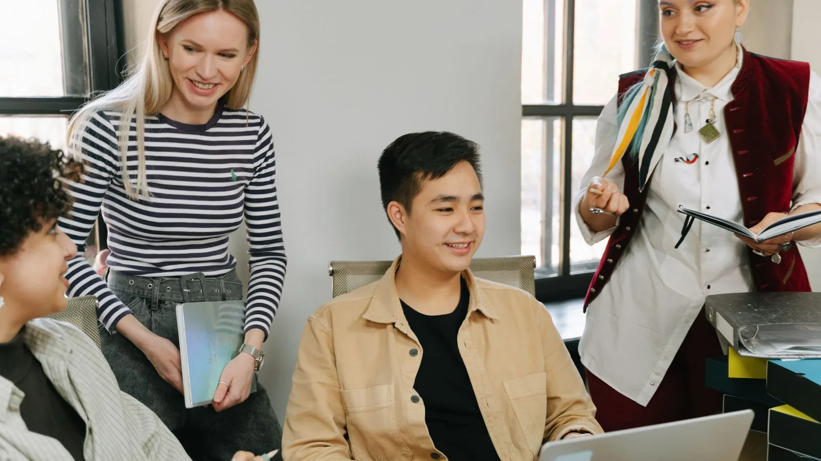 Colleagues welcoming a new team member in a bright office