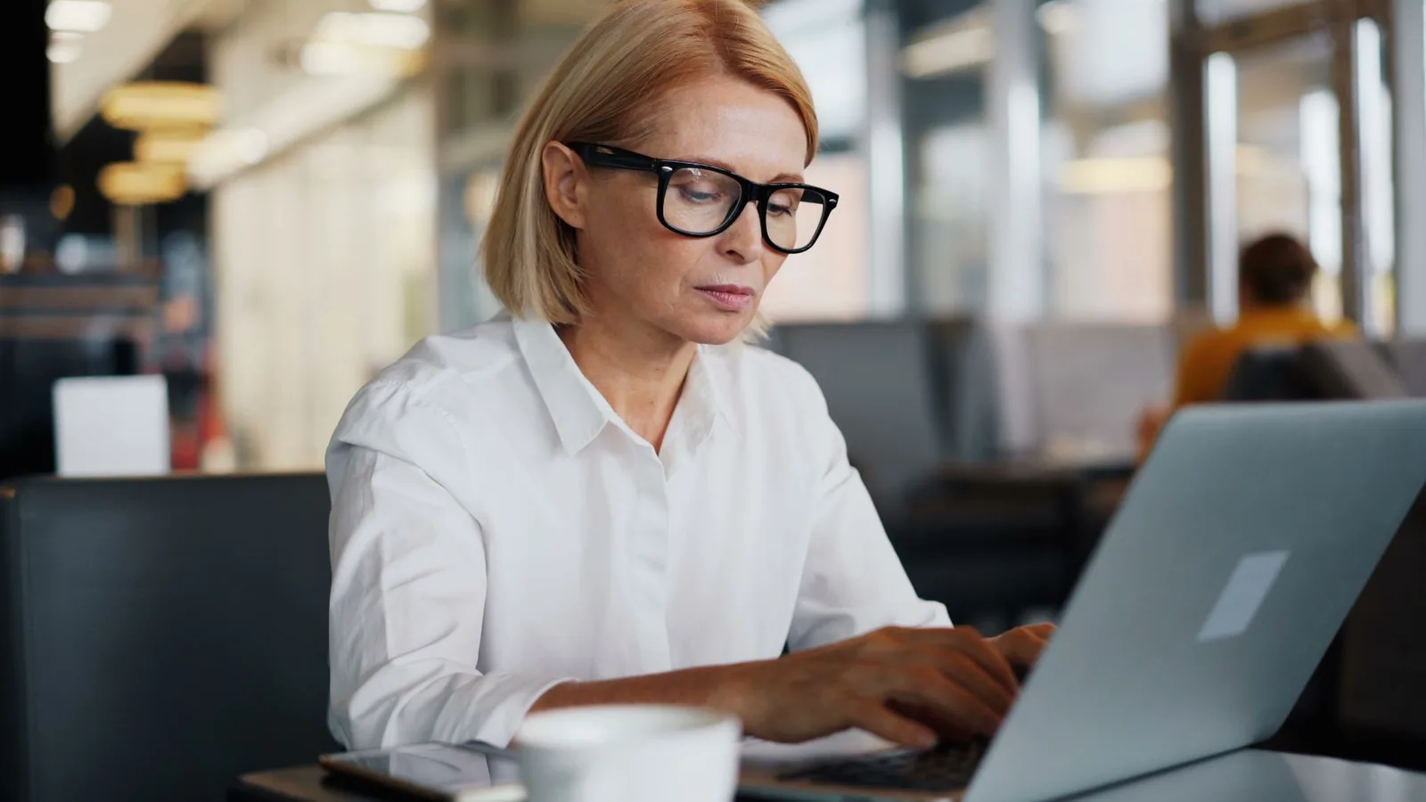A woman concentrating on her laptop screen